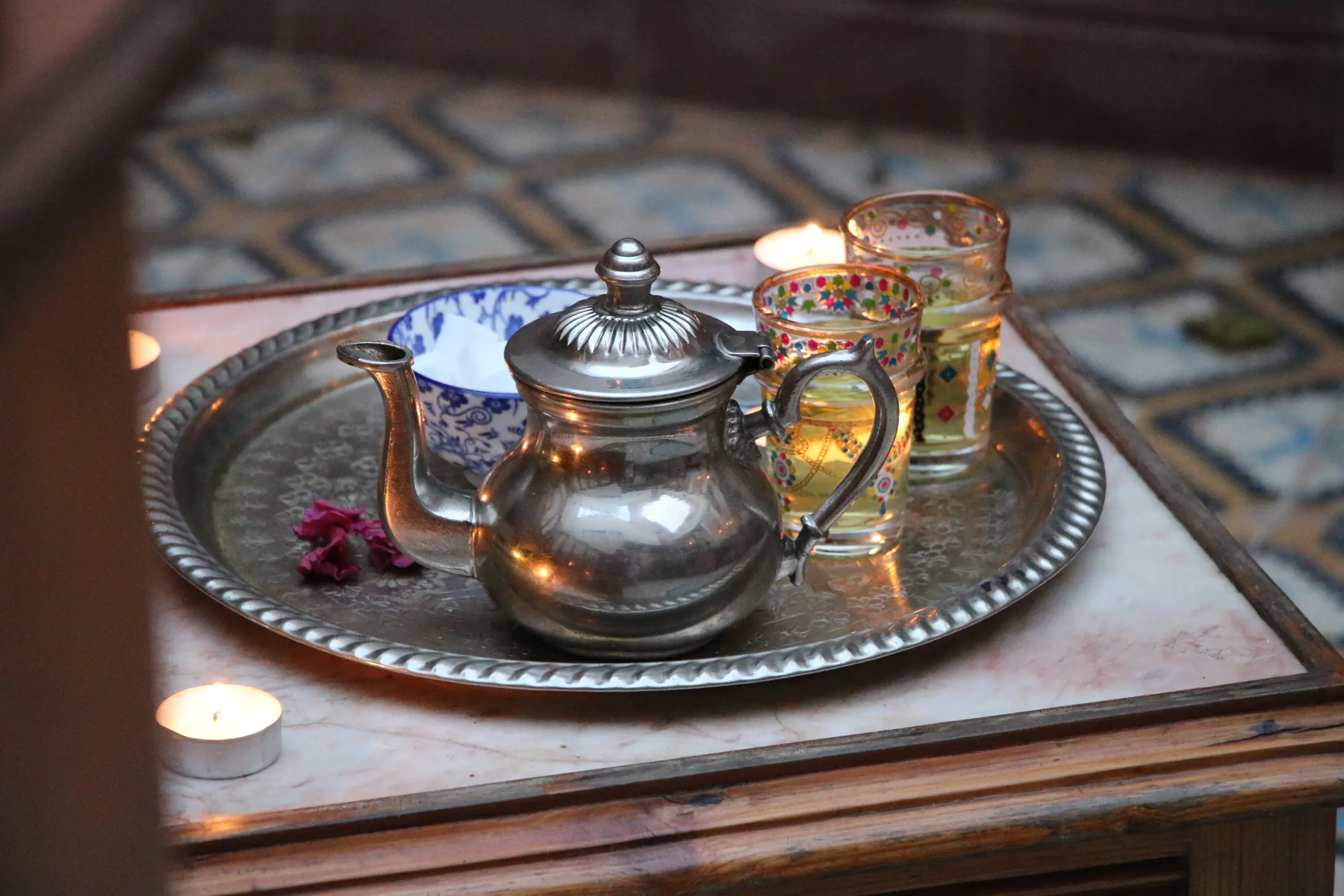 A silver tea tray with a Moroccan teapot and glasses