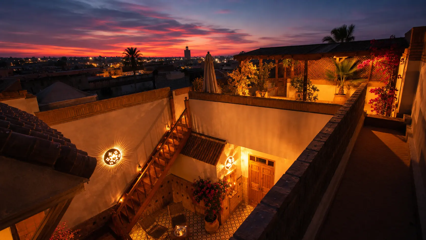 Sunset over the rooftops and minarets of the Marrakech Kasbah, seen from the riad's terrace