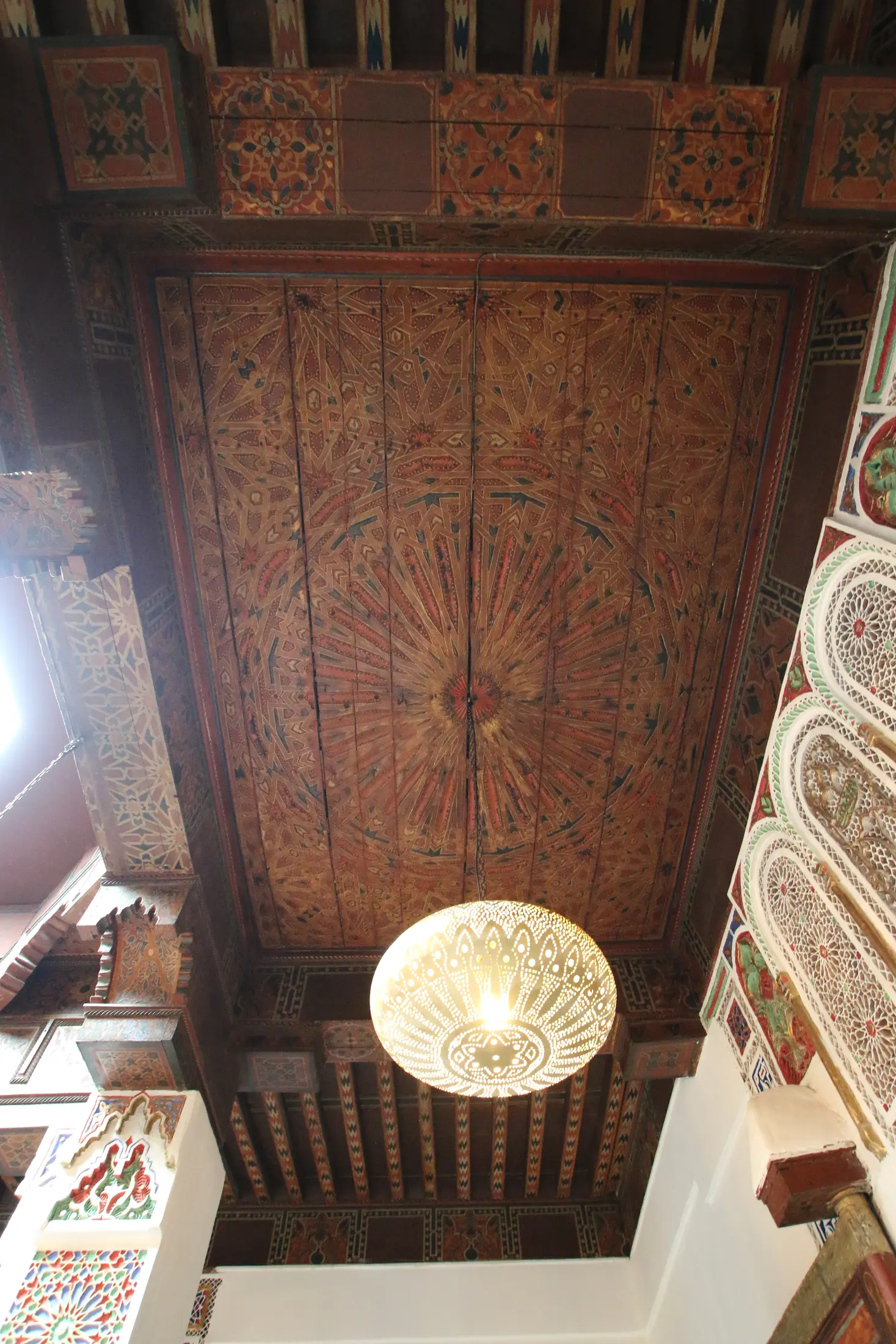 The 16th-century painted wooden ceiling above the salon