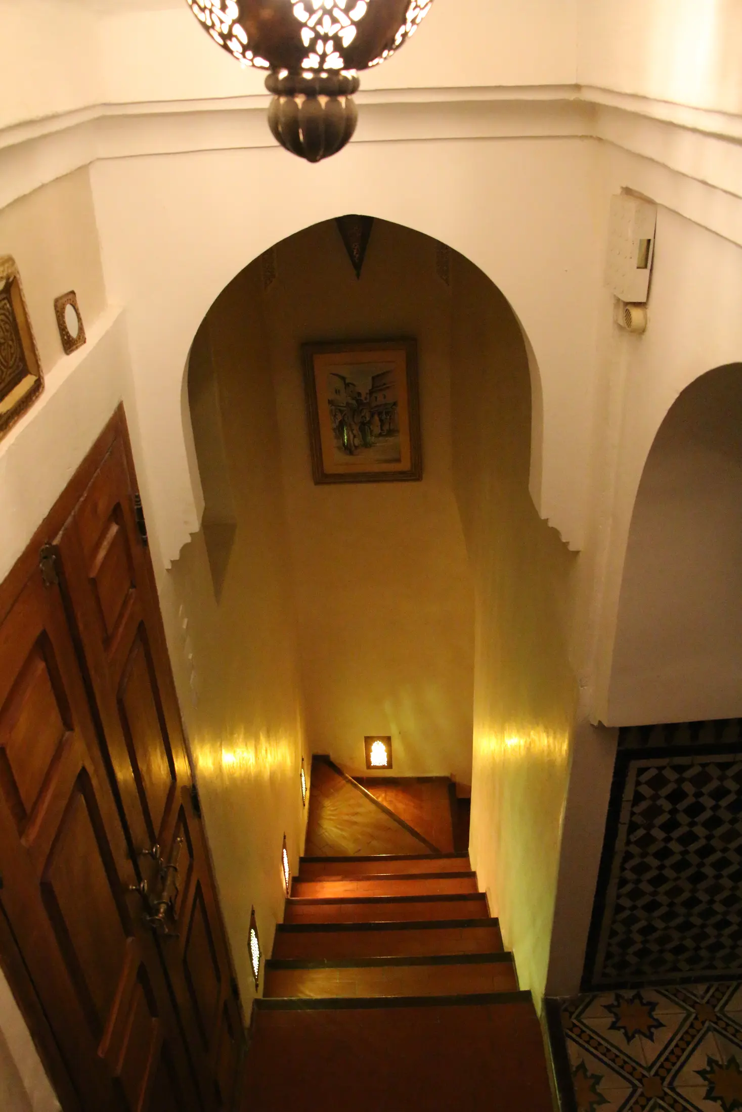 The interior staircase lit by lanterns